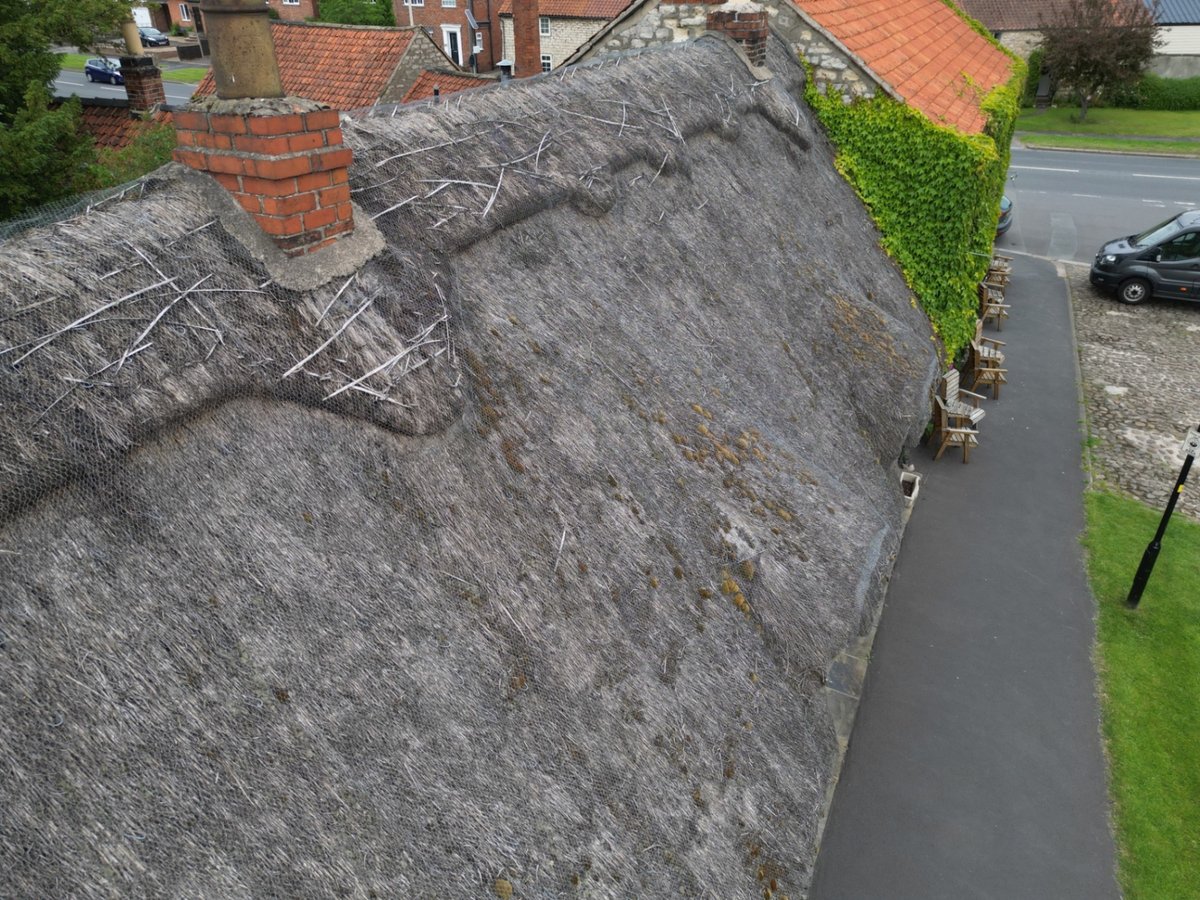 Weathered water-reed thatched roof viewed by drone