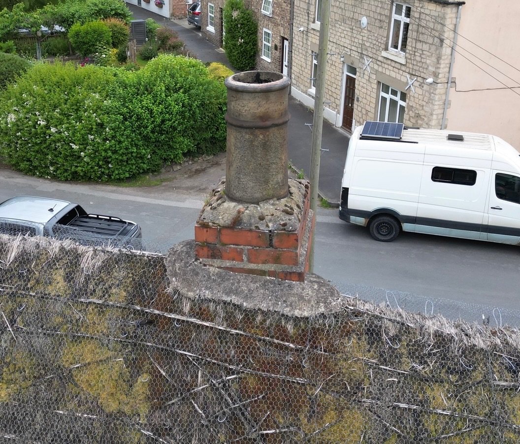 Chimney and cement weathering to traditional thatched roof