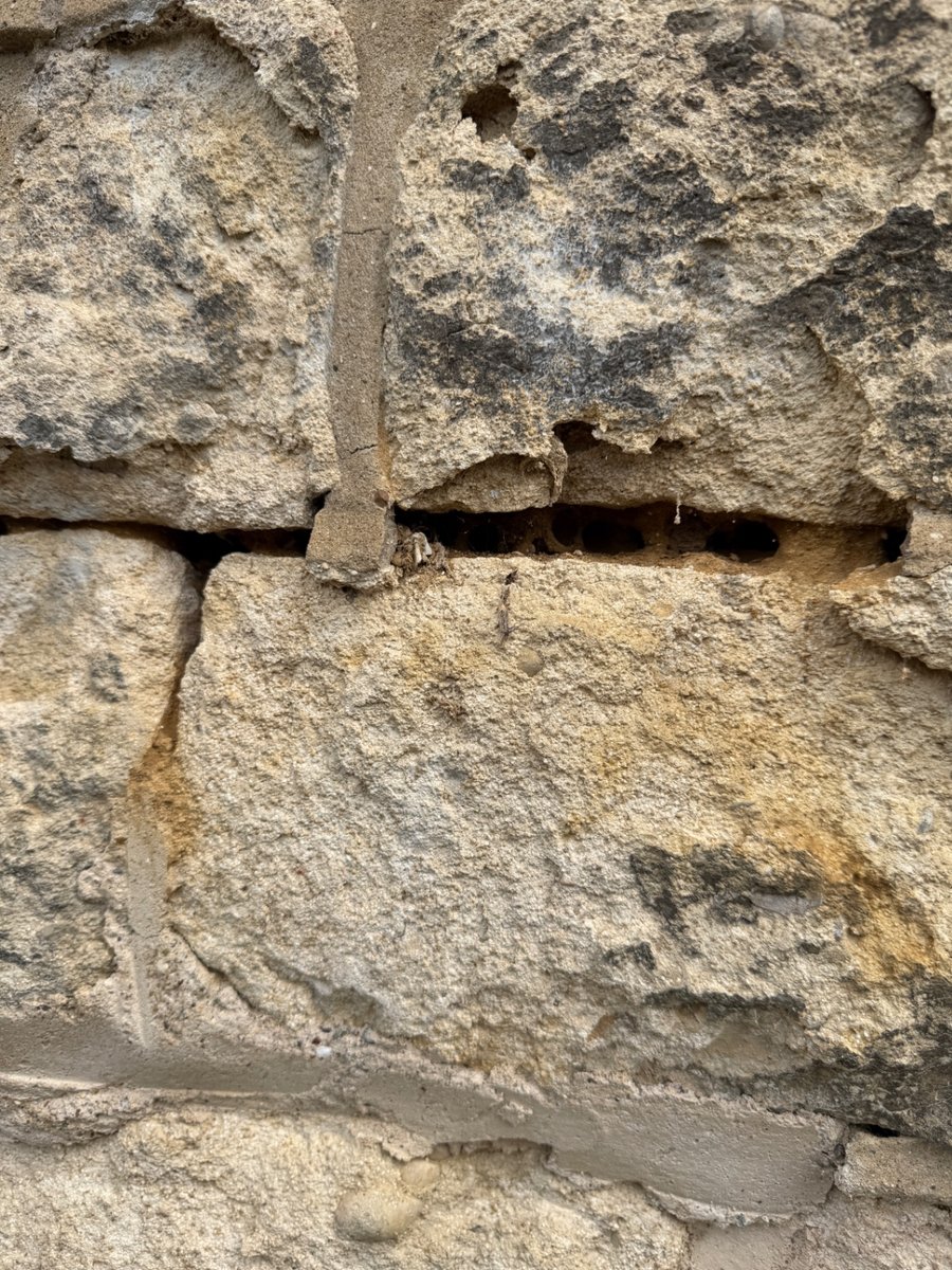 Open joints and cement pointing to historic sandstone masonry