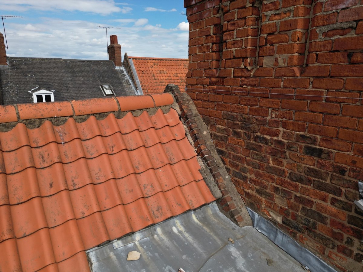Defective mortar weathering at roof abutment