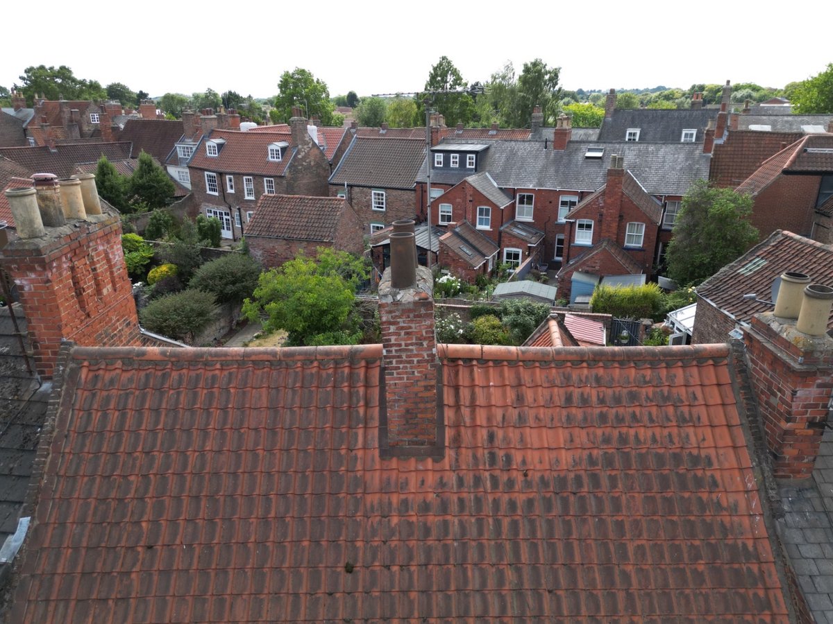Leaning historic brick chimney stack